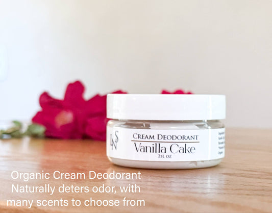 'Lis Noir Skincare' 'LNS' 'Leading Naturals Skincare' organic cream deodorant in a 2oz jar on wood counter in front of red roses and plantain.